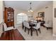 Formal dining room with a large window, contemporary chandelier, and light-colored walls that create a cozy atmosphere at 9542 Spring Cir, Port Charlotte, FL 33981