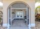A welcoming front porch with tiled flooring and double doors leading into the house at 9542 Spring Cir, Port Charlotte, FL 33981