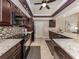 Updated kitchen with dark cabinetry, granite countertops, and stainless steel appliances create a stylish and functional space at 9542 Spring Cir, Port Charlotte, FL 33981