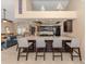 Modern kitchen with a large island with barstool seating, dark cabinetry, and stainless steel appliances at 9542 Spring Cir, Port Charlotte, FL 33981