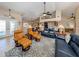 Bright living room featuring vaulted ceilings, fan, and comfortable leather furniture on an patterned area rug at 9542 Spring Cir, Port Charlotte, FL 33981