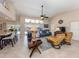 Bright living room with high ceilings, tile floors, and a seamless connection to the outdoor living space at 9542 Spring Cir, Port Charlotte, FL 33981