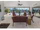 The cozy screened-in patio overlooking the pool and waterfront offers ample seating and a grill at 9542 Spring Cir, Port Charlotte, FL 33981