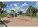 Community playground with a slide, swings, and climbing structure, perfect for outdoor Gathering fun at 9542 Spring Cir, Port Charlotte, FL 33981