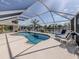 Beautiful screened-in pool area, perfect for relaxing and entertaining with a view of the waterfront in the background at 9542 Spring Cir, Port Charlotte, FL 33981