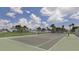 Community tennis court with green surface and chain-link fence, ideal for recreational games at 9542 Spring Cir, Port Charlotte, FL 33981