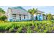 Well-maintained clubhouse exterior showing lush landscaping and beautiful blue accents at 9800 Bright Water Dr, Englewood, FL 34223
