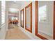 Hallway with wood floors, mirrors, and an opening to the living room and kitchen at 9800 Bright Water Dr, Englewood, FL 34223