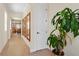 Hallway with wood floors, mirrors, neutral paint and a houseplant at 9800 Bright Water Dr, Englewood, FL 34223