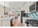 Kitchen with stainless appliances, an island and great view of the living area at 9800 Bright Water Dr, Englewood, FL 34223