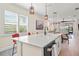 Open kitchen featuring a large center island and pendant lighting with hardwood floors at 9800 Bright Water Dr, Englewood, FL 34223