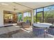 Large covered patio with a ceiling fan offers indoor/outdoor living with sliding door to the living room at 9800 Bright Water Dr, Englewood, FL 34223