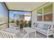 Relaxing screened patio features comfortable seating, a gas grill and views of the home's backyard at 9800 Bright Water Dr, Englewood, FL 34223
