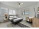 Stylish bedroom with neutral color palette, window with blinds, and chic furnishings at 10399 Abaco Falls Dr, Englewood, FL 34223