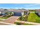Desirable single-Gathering home with a paver driveway, a gray tile roof, and manicured landscaping at 10399 Abaco Falls Dr, Englewood, FL 34223