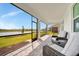 Screened patio with comfortable seating offering picturesque views of the lake at 10399 Abaco Falls Dr, Englewood, FL 34223
