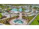 Resort-style community pool featuring multiple swimming areas, lounge chairs, and tropical landscaping at 10399 Abaco Falls Dr, Englewood, FL 34223