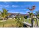 Beautiful backyard with lush lawn, landscaped plants, and screened-in patio for waterfront living at 10139 Kansas City St, Port Charlotte, FL 33981