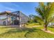 Spacious backyard with a screened patio, lush greenery, and access to the waterway for outdoor enjoyment at 10139 Kansas City St, Port Charlotte, FL 33981