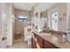 Bright bathroom with granite counters, tile floors and a spacious tiled walk-in shower at 10139 Kansas City St, Port Charlotte, FL 33981