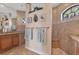 Bright bathroom with granite counters, tile floors and a spacious shower featuring a bench at 10139 Kansas City St, Port Charlotte, FL 33981