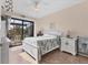 Cozy bedroom with tile floors, ceiling fan and access to a screened outdoor patio at 10139 Kansas City St, Port Charlotte, FL 33981