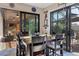 Dining area with access to a screened-in patio, tile flooring and decorative wall art at 10139 Kansas City St, Port Charlotte, FL 33981