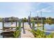 Beautiful waterfront view of a private dock with boat lift, perfect for enjoying the water at 10139 Kansas City St, Port Charlotte, FL 33981