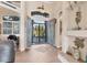 Elegant foyer with decorative glass doors, tiled floors, and natural light at 10139 Kansas City St, Port Charlotte, FL 33981