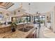 Open kitchen area featuring a breakfast bar with granite countertops and stainless steel appliances at 10139 Kansas City St, Port Charlotte, FL 33981