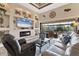 Spacious living room with a fireplace, large windows, and seamless access to the screened lanai at 10139 Kansas City St, Port Charlotte, FL 33981