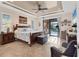 Bright main bedroom with tile flooring, access to the backyard, neutral color palette, and coastal decor at 10139 Kansas City St, Port Charlotte, FL 33981