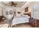 Main bedroom with a tray ceiling, tile floors, a ceiling fan and plenty of natural light at 10139 Kansas City St, Port Charlotte, FL 33981