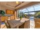 Inviting screened outdoor dining and kitchen area with a pool and picturesque water views at 10139 Kansas City St, Port Charlotte, FL 33981