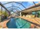Inviting screened-in pool with a hot tub and ample seating, perfect for relaxing and enjoying the outdoors at 10139 Kansas City St, Port Charlotte, FL 33981