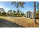 A storage shed in a spacious backyard featuring tall trees and providing ample storage at 10139 Kansas City St, Port Charlotte, FL 33981