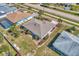 Aerial view of beautifully landscaped yard with mature palms and flowering bushes at 1048 Ulrey Ln, Englewood, FL 34223