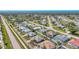 Vast neighborhood with diverse roof styles, manicured yards, and tranquil waterfront views in the distance at 1048 Ulrey Ln, Englewood, FL 34223