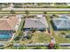 Aerial view of home with landscaped yard, patio and privacy fence at 1048 Ulrey Ln, Englewood, FL 34223
