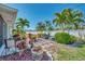 Serene backyard featuring a tiled patio, lush landscaping, and ample space for outdoor enjoyment at 1048 Ulrey Ln, Englewood, FL 34223