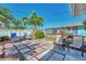 Charming backyard with a tiled patio, palm trees, and a screened-in pool, perfect for outdoor relaxation at 1048 Ulrey Ln, Englewood, FL 34223
