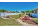 Well-maintained yard with white fence, landscaping and grass at 1048 Ulrey Ln, Englewood, FL 34223