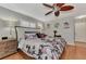 The bright bedroom features stylish decor, neutral walls, wood floors, and a large bed at 1048 Ulrey Ln, Englewood, FL 34223