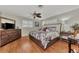 This bedroom features a ceiling fan, a dresser with TV, and bright natural light at 1048 Ulrey Ln, Englewood, FL 34223