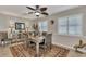 Cozy dining room with a decorative ceiling fan and shuttered windows, and horse sculpture at 1048 Ulrey Ln, Englewood, FL 34223