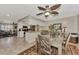 Open-concept dining area with stylish decor and transition to kitchen and other living area at 1048 Ulrey Ln, Englewood, FL 34223