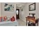 Inviting entryway with tiled floor, front door with oval window, art, bench and vintage sewing machine at 1048 Ulrey Ln, Englewood, FL 34223