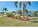 Well-maintained home with palm trees and lush landscaping, enhanced by decorative mulch beds at 1048 Ulrey Ln, Englewood, FL 34223