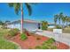 Charming home featuring a two-car garage and lush landscaping with mulch and a well maintained lawn at 1048 Ulrey Ln, Englewood, FL 34223