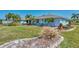 A beautifully landscaped exterior showcasing a well-maintained lawn and vibrant greenery at 1048 Ulrey Ln, Englewood, FL 34223
